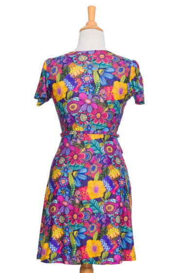 Selena Dress by Rien ne se Perd, Colourful Flowers, back view,  wrap dress, faux-wrap neckline, short sleeves, tie at waist, fit and flare shape, above the knee, sizes XS to XXL, made in Quebec 