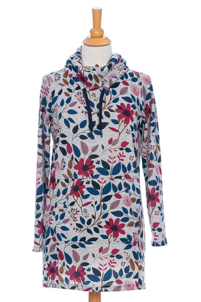 The Genevrier Tunic by Rien ne se Perd in Floral, featuring a turtleneck with a drawstring, a kangaroo pocket, long sleeves, and a straight cut, is shown on a mannequin in front of a white background. 