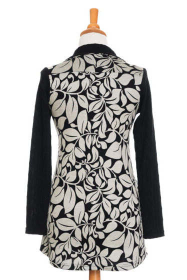 The back of the The Marcelle Tunic by Rien ne se Perd in Foliage Black and White is shown in front of a white background 