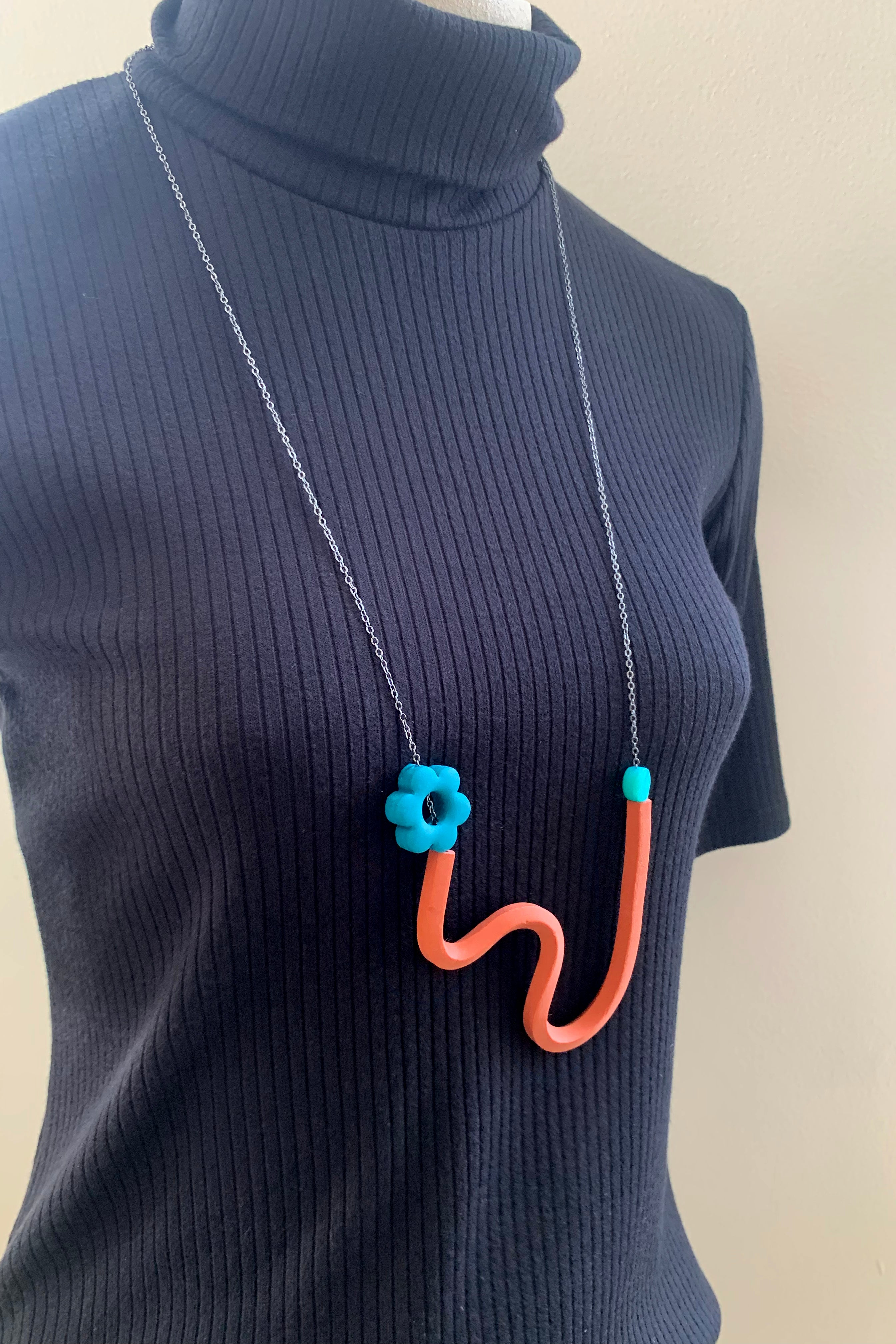 Terracotta Squiggle Necklace with Peacock Flower and transparent teal beads
